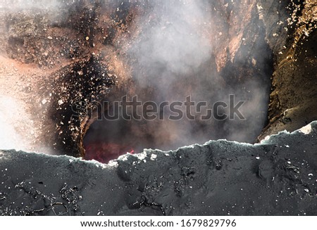 Lava Lake of Masaya Volcano Santiago Crater in Nicaragua close view of red smokey dangerous bubbling kettle bowl emitting slufur dioxide Royalty-Free Stock Photo #1679829796