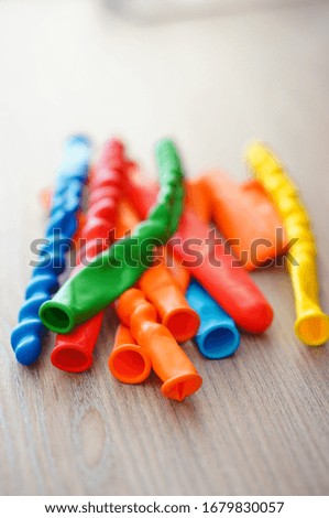 A lot of colorful balloons in different shapes on a wooden surface