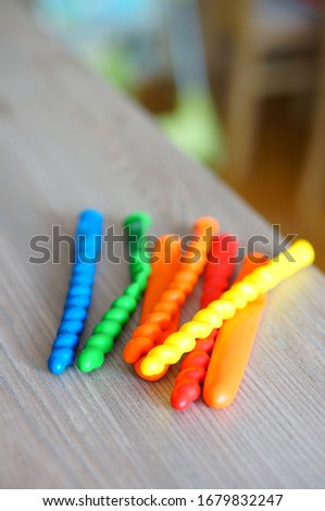A lot of colorful balloons in different shapes on a wooden surface