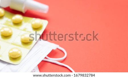 Medical protective mask and pills over red background.  Healthcare. Coronovirus. Text space