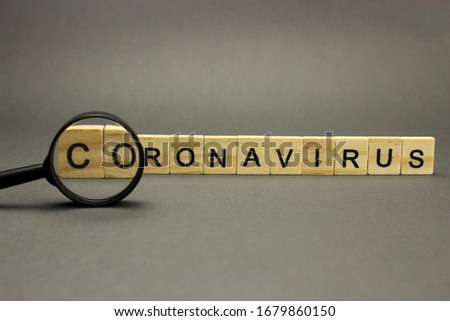 Inscription coronavirus in wooden letters on a grey background. Dangerous 2019-nCov flu infection