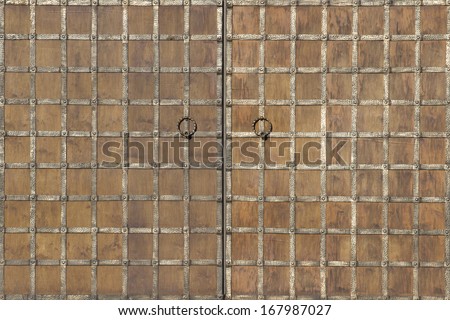 Wood and metal. Surface of vintage gate with wrought ribbons.