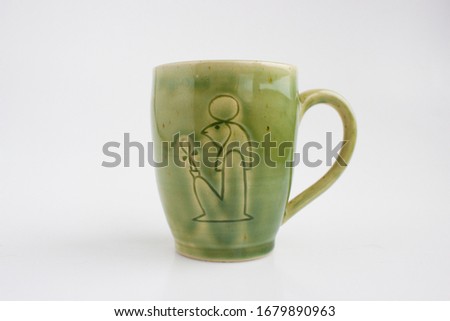mug with the image of the god Ra. Author's ceramics. Color Celadon egyptian symbolism.