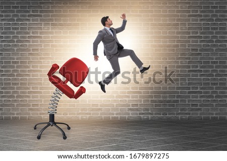 Promotion concept with businessman ejected from chair Royalty-Free Stock Photo #1679897275
