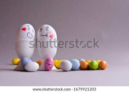 Eggs with a face. Mom, dad and a lot of little colored kids eggs. The Creative idea for decorating Easter Sunday. Copy space 
