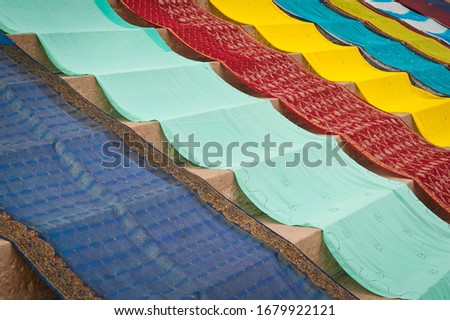 Coloured saris laid out to dry on stairs, ghat, Varanasi also known as Banaras, Uttar Pradesh, India, Asia