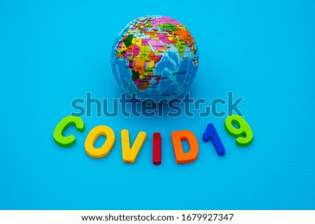 Globe and text COVID 19 on a blue background. Coronavirus / Corona virus concept. The spread of corona virus in the World.