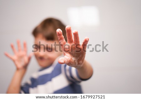 The boy washes his hands with soap. children's hygiene during epidemics