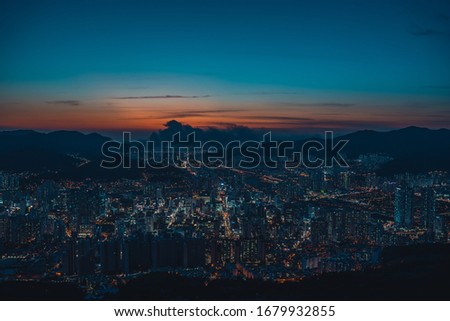 Ah, the picture shows the panoramic view of Busan in Korea taken in the mountain.