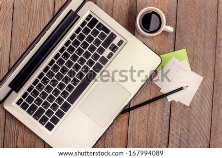 Laptop and Coffee Cup on Wooden Table Royalty-Free Stock Photo #167994089