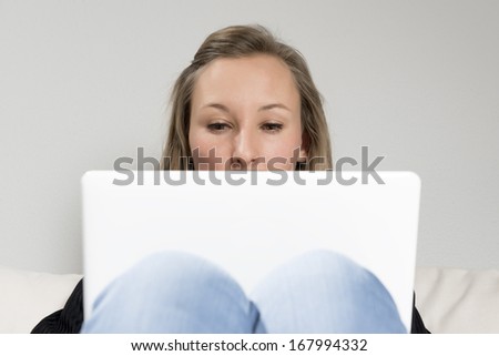 Picture of a woman sitting on sofa with laptop