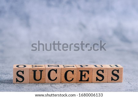 Wood cube letter of SUCCESS with copy space. Idea of motivation and inspiration in business vision and corporate management strategy. Leadership lead teamwork to reach goal or achievement.