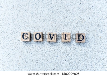 "Covid-19" Wooden alphabets concept with terrazzo background detail 