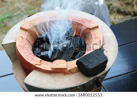 Smoke from traditional charcoal stove for cooking and grilling food or barbecue.