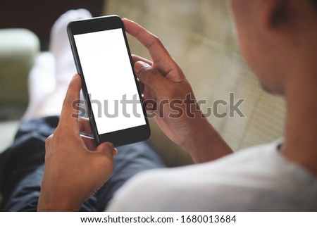 Cropped shot view of man hands holding smart phone with blank copy space screen for your text message or information content, female reading text message on cell telephone during in urban setting. Royalty-Free Stock Photo #1680013684