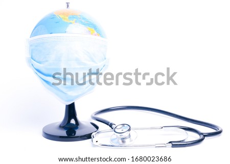A picture of globe wearing mask with stethoscope insight. World are combating the worse epidemic call covid-19.