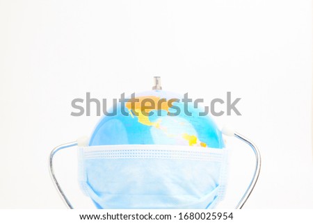 A half view picture of globe wearing medical mask and stethoscope. World are combating the worse epidemic call covid-19.