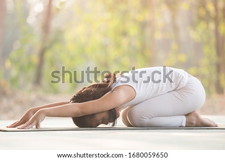 calmness and relax, female happiness.Horizontal, blurred background. little asian girl meditates while practicing yoga. freedom concept. calmness and relax, woman happiness. toned picture healthy life