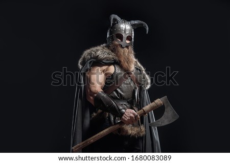 Warrior Viking in full arms with axe and shield on dark background Royalty-Free Stock Photo #1680083089