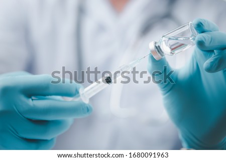 Concept fight against virus covid-19 corona virus, doctor or scientist in laboratory holding a syringe with liquid vaccines for children or older adults,Concept:diseases,medical care,science. Royalty-Free Stock Photo #1680091963