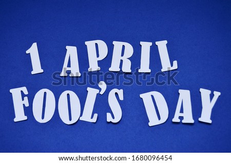 cut letters April April Fool's Day on a blue background