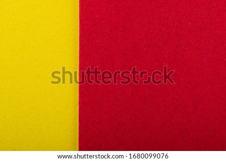 Yellow and red sheet of colored velvet paper. Bright color background. Horizontal orientation. Square and vertical strip. Top view flat lay with copy space.