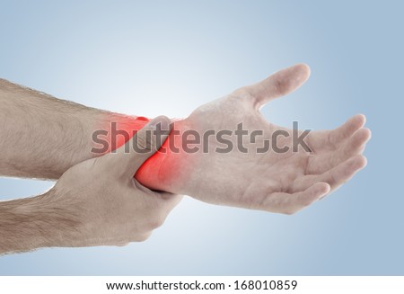 Acute pain in a man palm. Male holding hand to spot of palm-ache. Concept photo with Color Enhanced blue skin with read spot indicating location of the pain. 