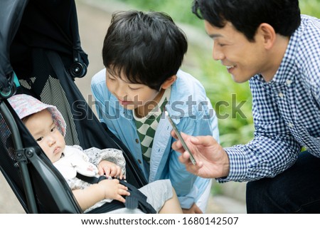 A father shooting a baby in a stroller