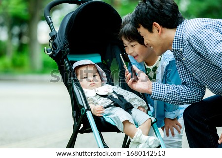 A father shooting a baby in a stroller