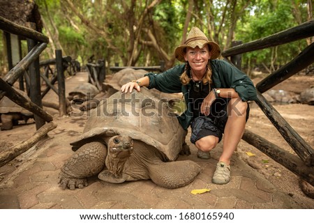 Young woman with a turtle, Zanzibar, Tanzania, Africa Royalty-Free Stock Photo #1680165940