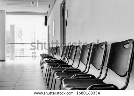 Black and white photo of empty chairs on waiting area in empty school university