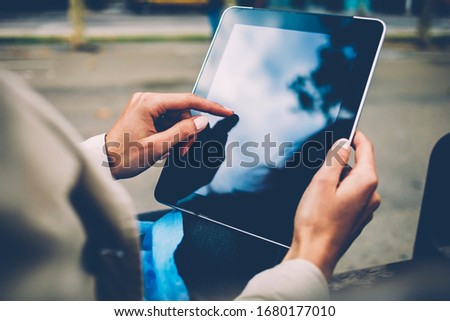 Cropped image of female hands tapping on blank screen of touch pad with copy space area for internet advertising or social website, millennial woman have online communication during web messaging