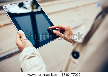 Selective focus on modern digital tablet with mock up screen for internet advertising, young woman searching wireless information for update notification on electronic touch pad with 4g connection