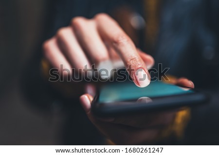 closeup finger touch screen smartphone light night city, girls using in hands mobile phone close up, online wi-fi internet, woman texting text message  Royalty-Free Stock Photo #1680261247