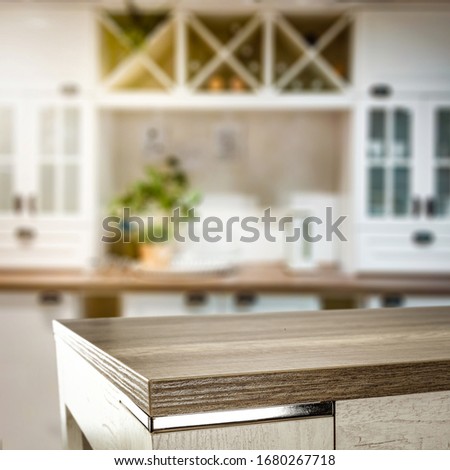 Table background of free space for your decoration and blurred window in kitchen interior. 