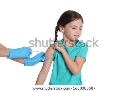 Doctor vaccinating little child on white background