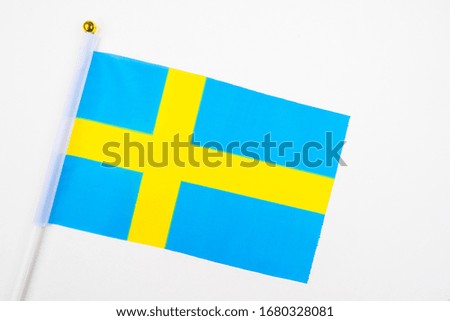 Flag of Sweden on a white background. Flag Of The Kingdom Of Sweden. Swedish flag close-up. Blue banner with yellow cross. Official symbol of the Swedish state.