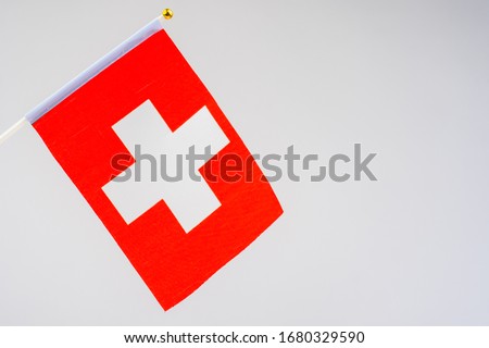 Swiss flag on a white background. Official flag of the Swiss Confederation. Red banner with a white cross. Official symbols of Switzerland.