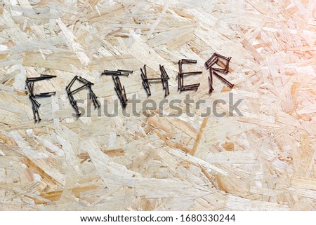 the inscription father on a plywood background