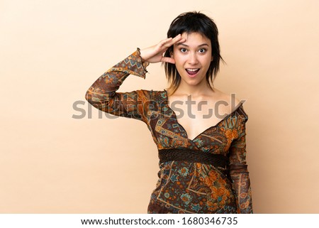 Indian woman isolated on beige background has realized something and intending the solution