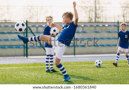 Young Boys in Sports Club on Soccer Football Training. Kids Enhance Soccer Skills on Natural Turf Grass Pitch. Football Practice Session for Children Youth Team of Professional School Soccer Club