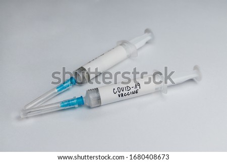 Vaccine and syringe injection with for treatment corona virus infection (novel coronavirus  nCoV 2019, COVID-19) on white background. Illuminated photo of dedicine infectious concept (vaccination).