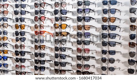 Sales rack of sunglasses. A colorful display of sunglasses for sale. Closeup.