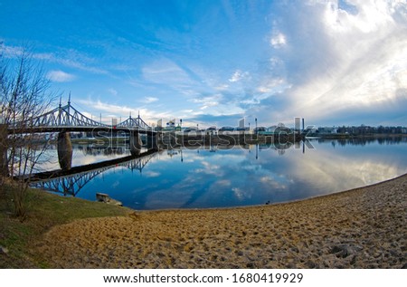 Riverview on the Volga river close to the Old Volga bridge, Old Churches, city Tver, Russia, evening light, cloudy sky, distortion perspective, fisheye, spring colors, 2020 Royalty-Free Stock Photo #1680419929