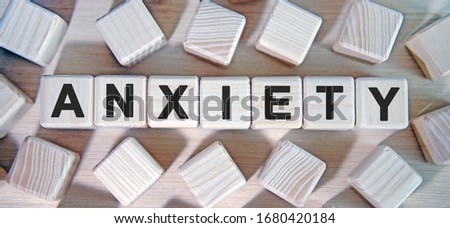 ANXIETY- text wooden cubes and many cubes around