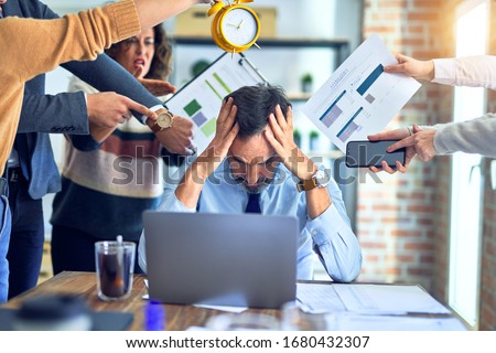Group of business workers working together. Partners stressing one of them at the office Royalty-Free Stock Photo #1680432307