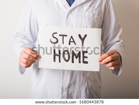 Doctor holding STAY HOME sign. Begging People with hashtag #StayHome to Fight Coronavirus. Anti nCoV Covid-19 Virus Royalty-Free Stock Photo #1680443878
