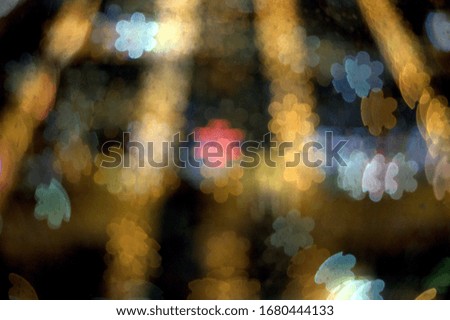 an array of five pointed stars on a dark golden background bokeh effect with special camera lens filter