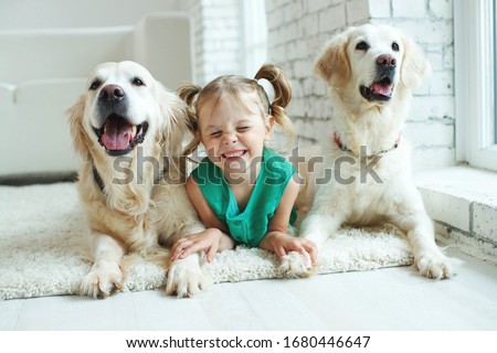 A child with a dog. Little girl with labrador retriever at home. Royalty-Free Stock Photo #1680446647