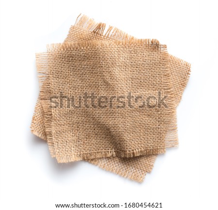 Old burlap fabric napkin, sackcloth piece isolated on white background Royalty-Free Stock Photo #1680454621